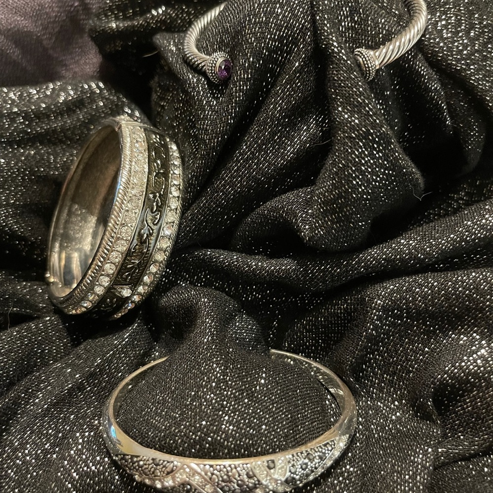 Three silver-tone bracelets/bangles, with rhinestone accents.